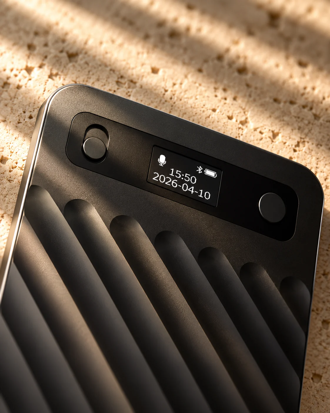 Close-up of the recorder’s two buttons and its small OLED screen